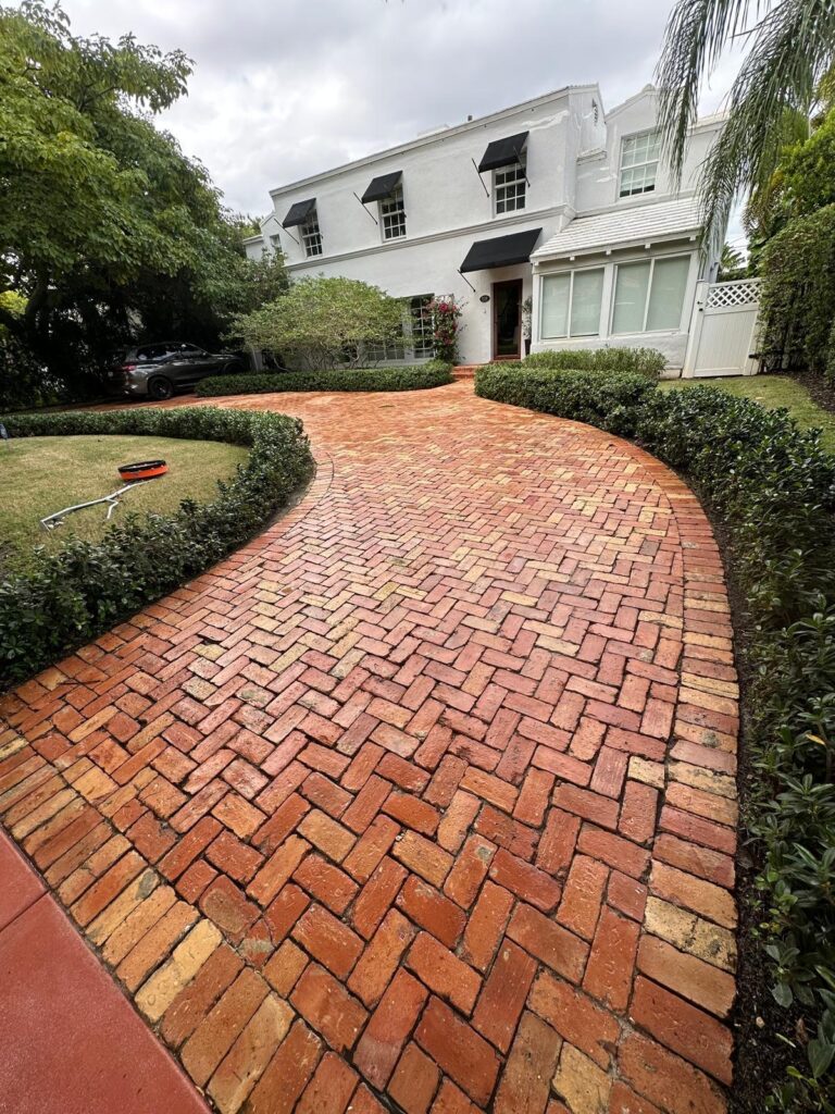 Same brick driveway looking vibrant and spotless after pressure cleaning